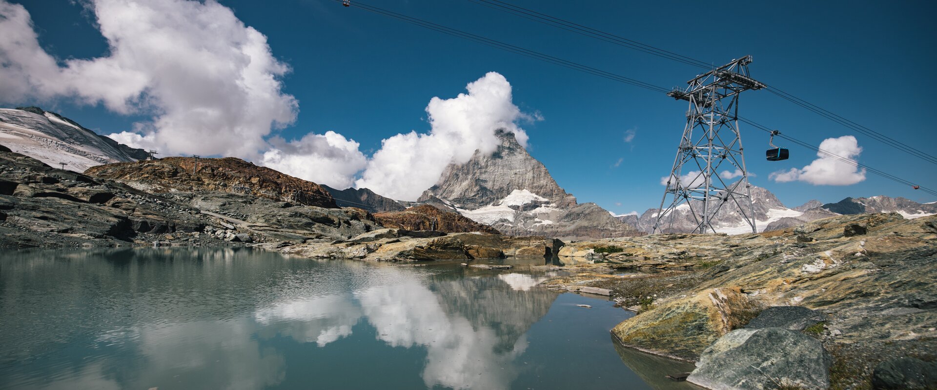 The Theodulsee on Trockener Steg, the Matterhorn and the gondolas of the Glacier Ride | © Mitch Pitmann